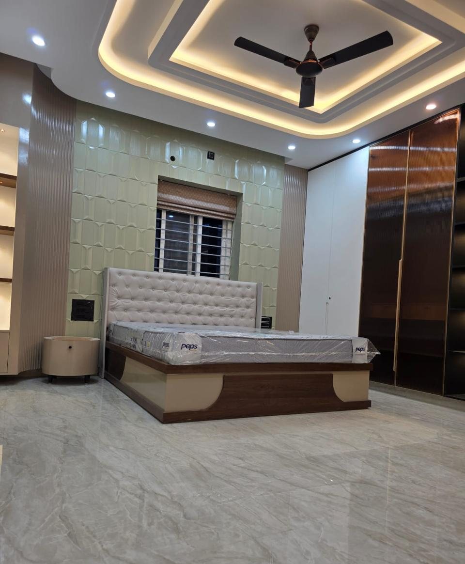 Bedroom with layered cove ceiling, 3D wall panels and fluted-glass wardrobe