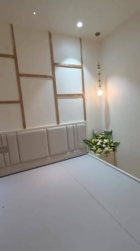 Bedroom walkthrough: lacquered-glass sliding wardrobe, oak-trim panelled wall and backlit vanity