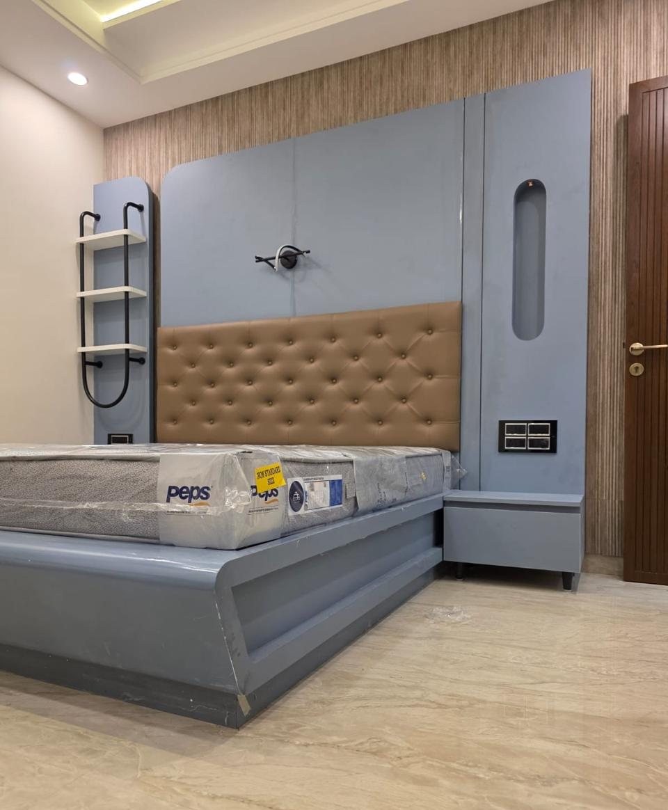 Bedroom with tufted headboard, full-height panelling and floating side tables