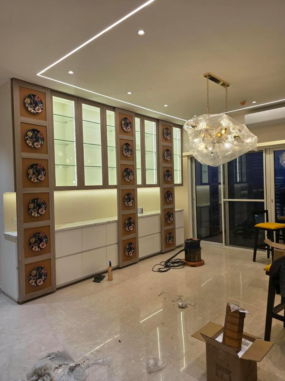 Dining display unit with decorative plate panels and lit glass cabinets