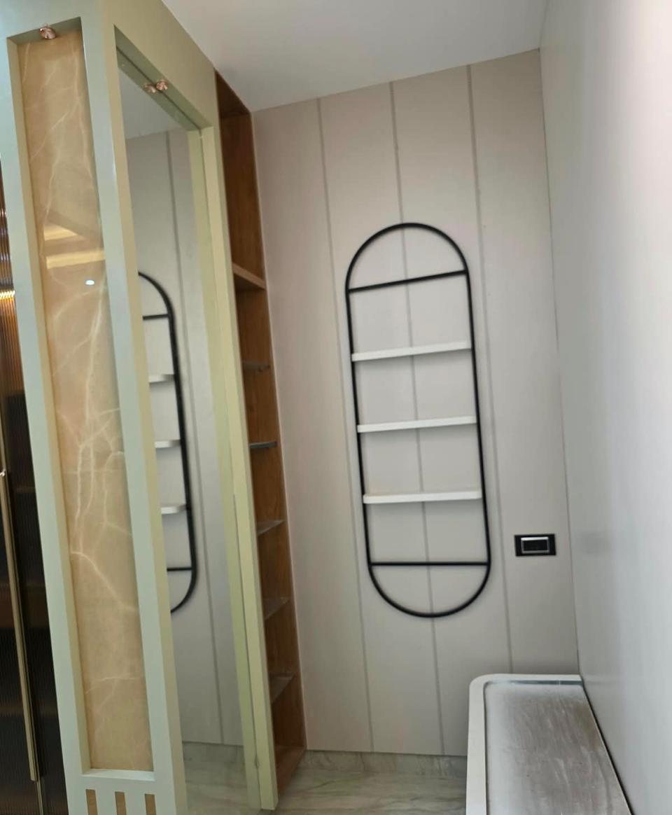 Dressing area with wall-mounted shelf frame, mirror and backlit stone panel