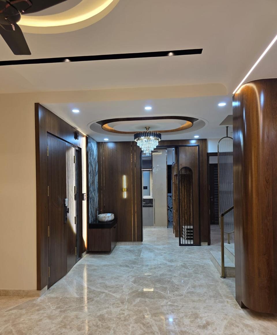 Entrance foyer with walnut panelling, oval cove ceiling and crystal chandelier