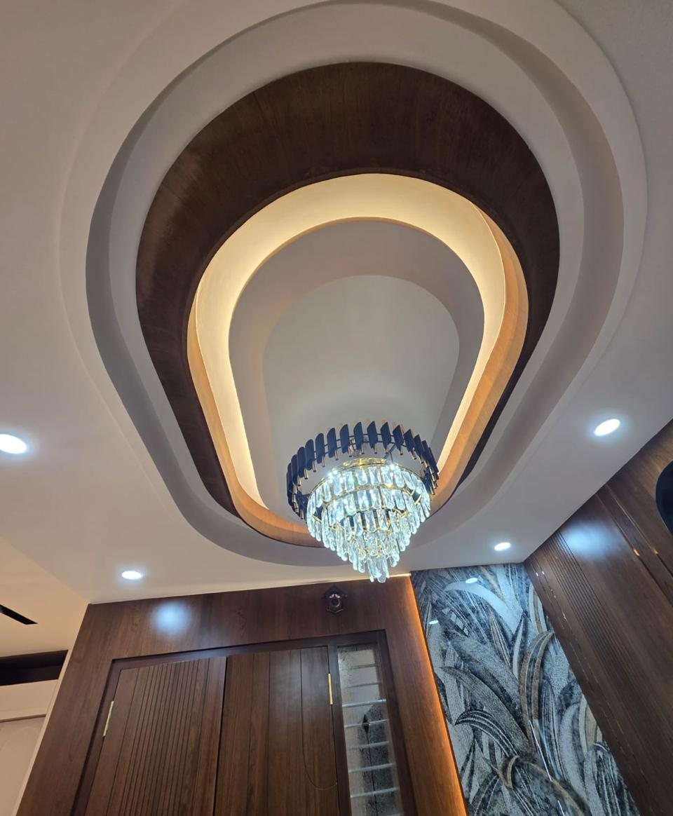 Foyer ceiling with walnut cove and chandelier