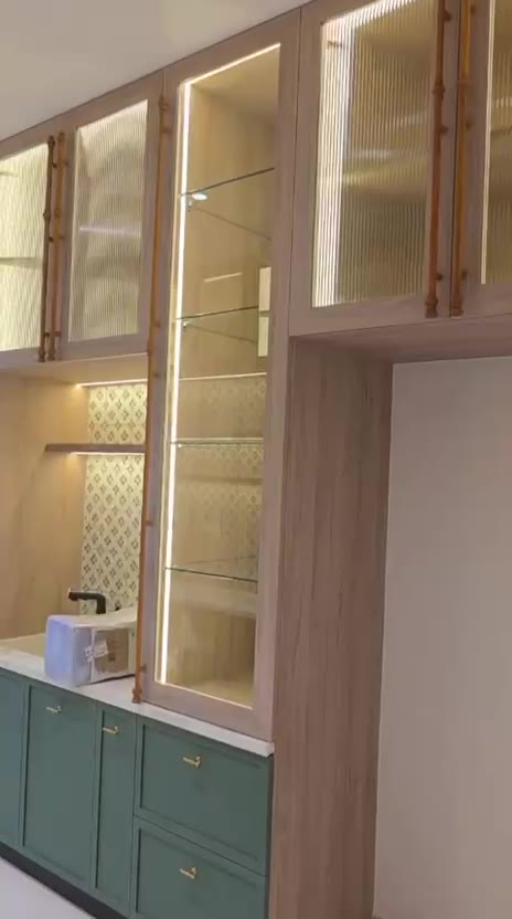 Green modular kitchen with patterned tile backsplash and wine rack