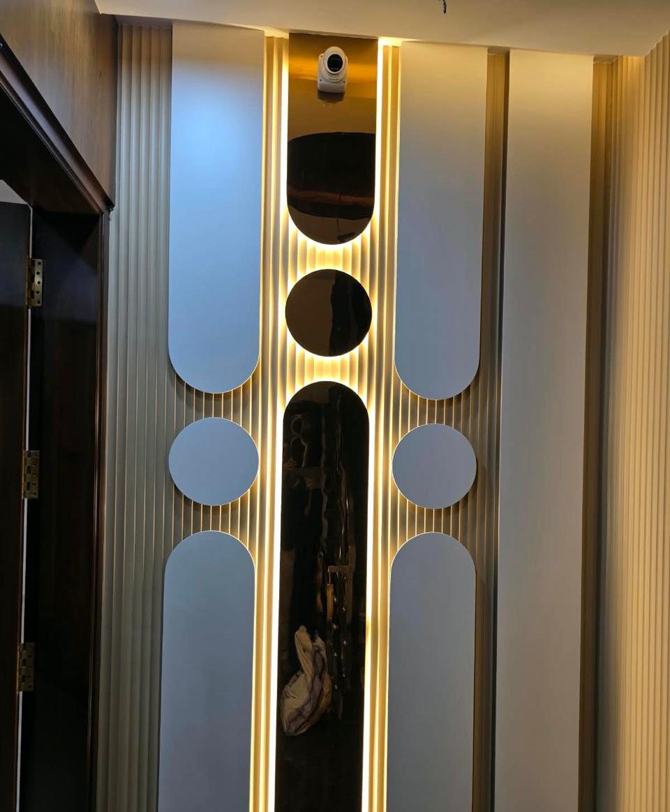 Backlit feature wall with mirror cut-outs and fluted panels