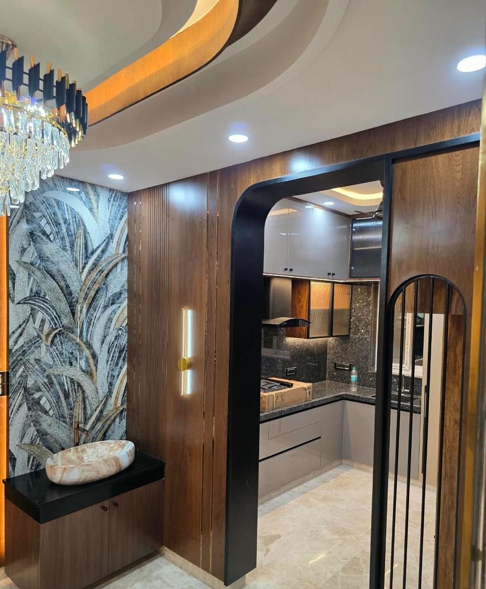 Mosaic feature wall with wash basin and black arched entry to the kitchen