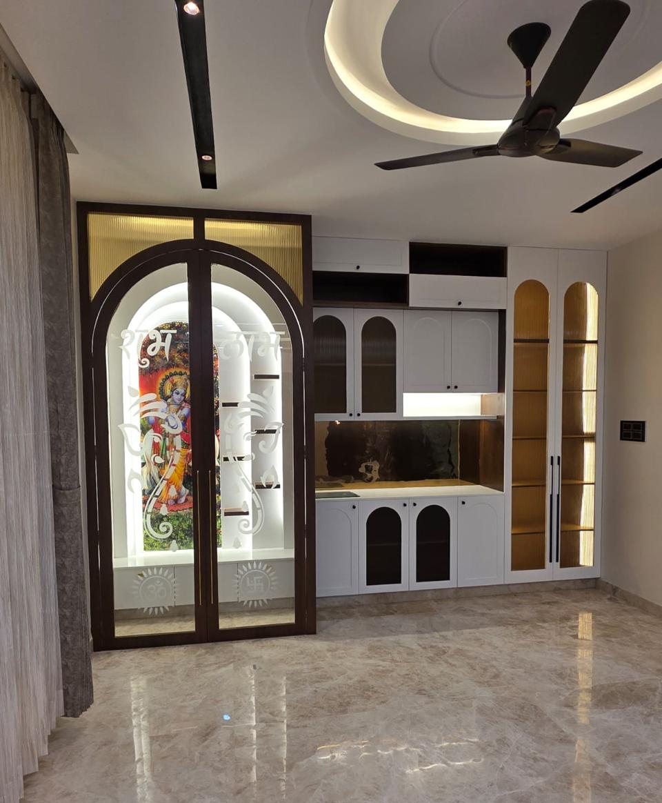 Pooja room with arched etched-glass doors beside a white crockery unit