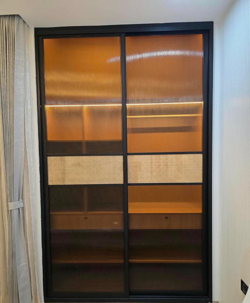 Sliding wardrobe with fluted glass, cane panels and interior lighting