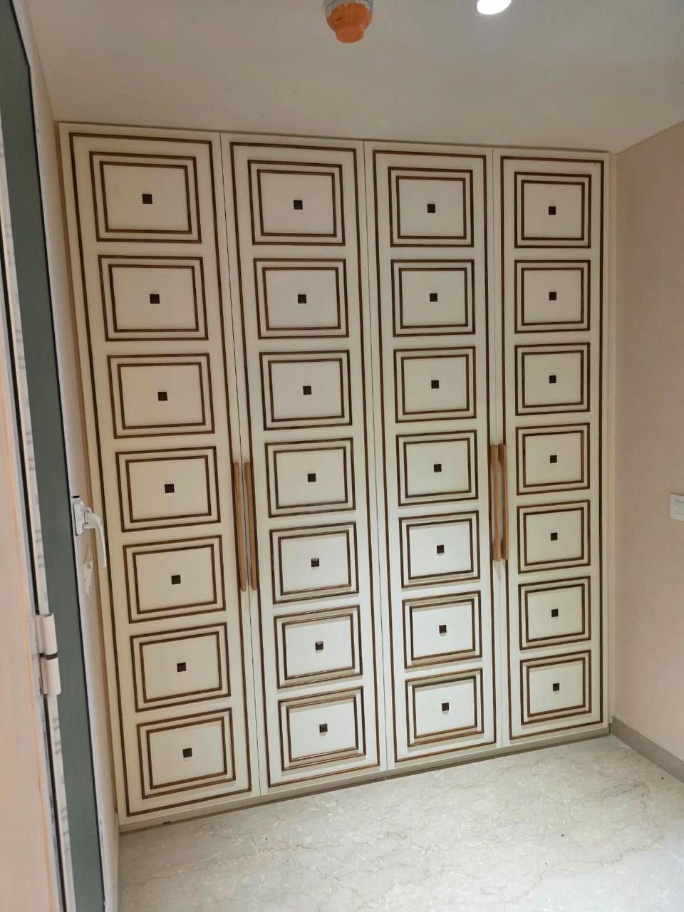 Wardrobe with inlaid panel detailing and wooden handles